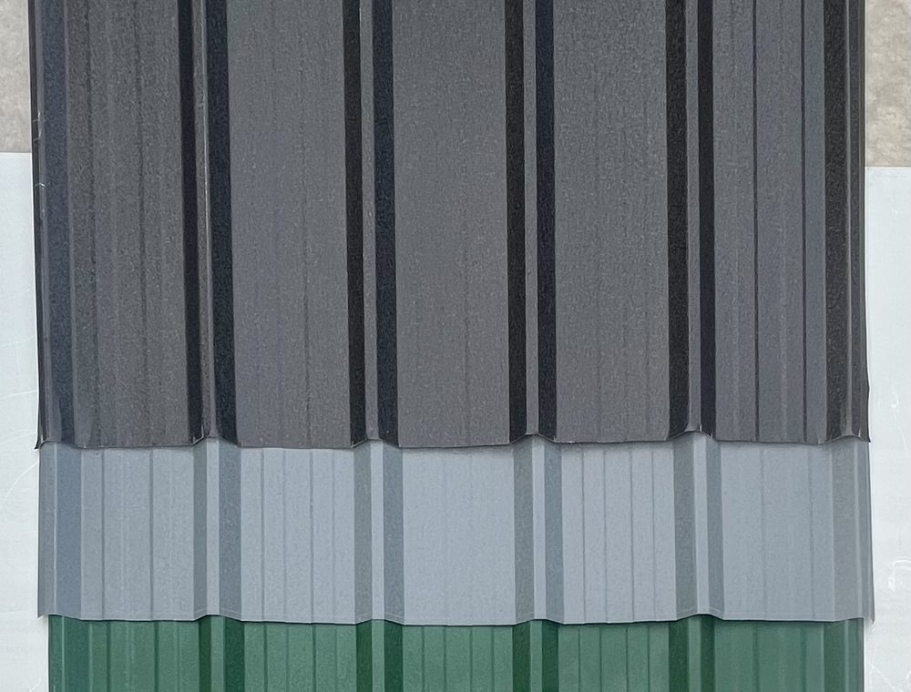 Anthracite, grey and juniper green box profile sheets, photographed in the yard