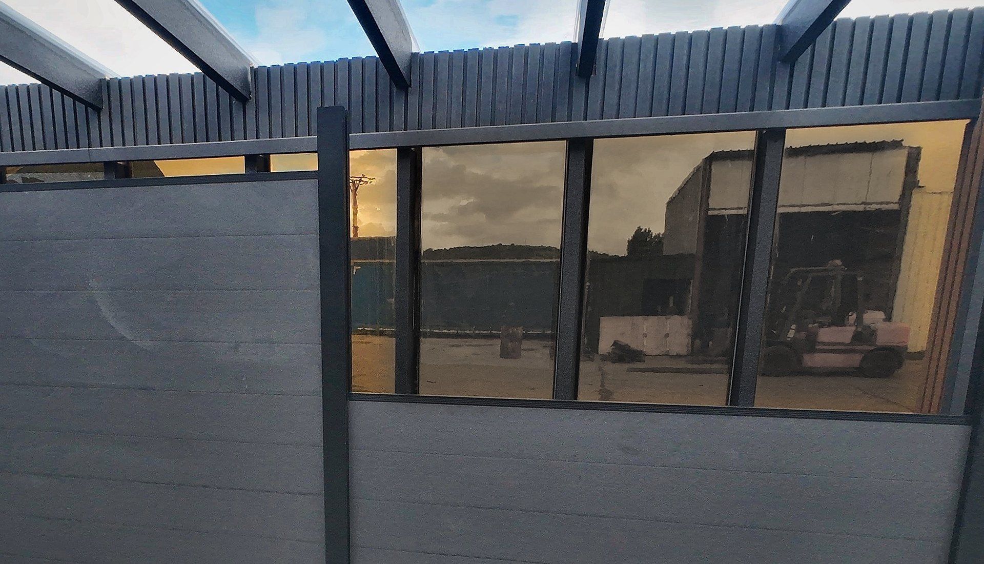 Clear polycarbonate roof sheeting on a steel framed lean-to